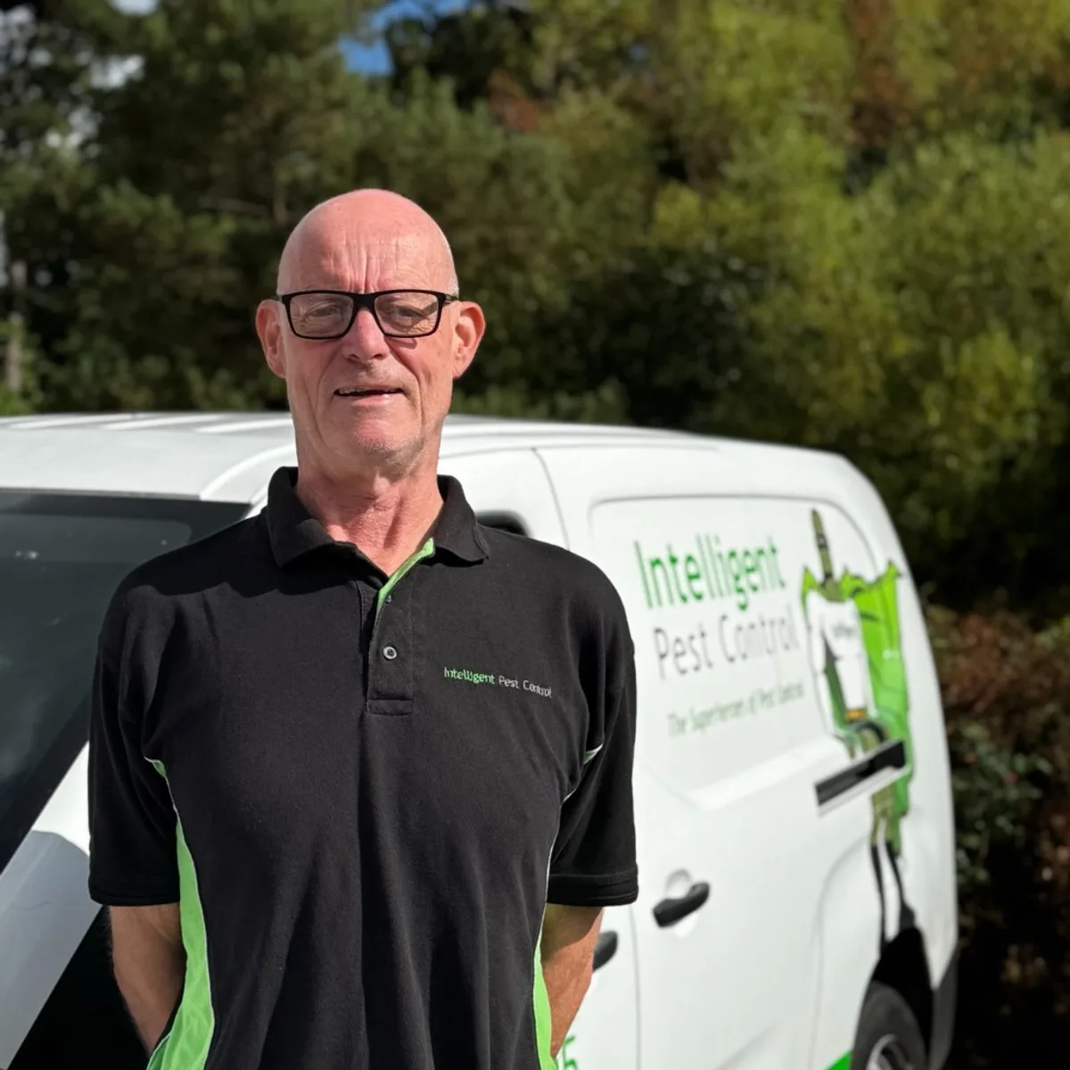 Jeremy Gillard of Intelligent Pest Control standing in front of a company van